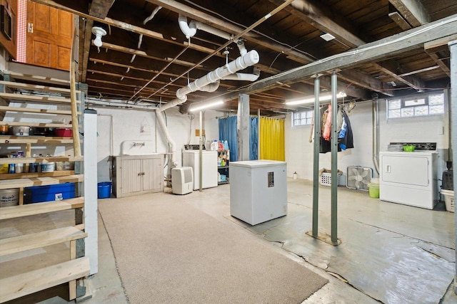 301 S Farmer St, Princeton, WI 54968 - below grade area featuring washer and clothes dryer, fridge, and plenty of natural light