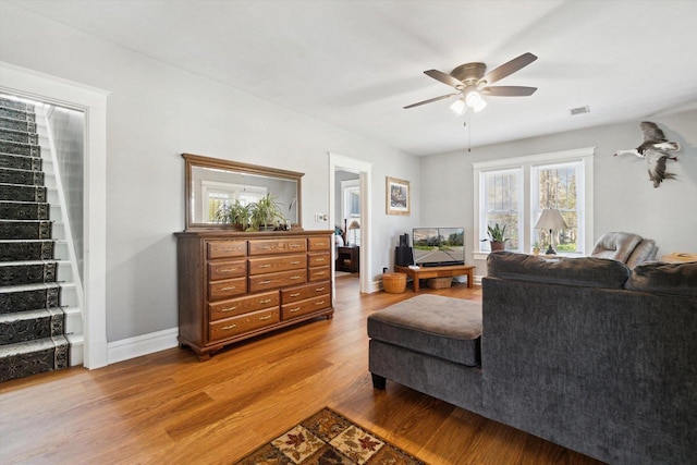 301 S Farmer St, Princeton, WI 54968 - living area featuring wood finished floors, a ceiling fan, baseboards, and stairway