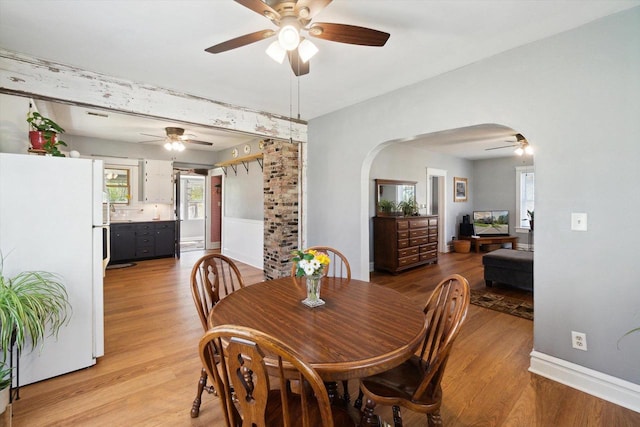 301 S Farmer St, Princeton, WI 54968 - dining room with ceiling fan, arched walkways, and light wood finished floors
