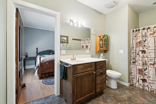 301 S Farmer St, Princeton, WI 54968 - ensuite bathroom with vanity, toilet, baseboards, and a shower with curtain