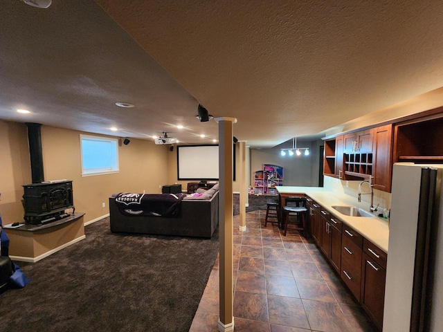 1120 W Blackhawk Dr, Fort Atkinson, WI 53538 - kitchen with a sink, a wood stove, open shelves, light countertops, and open floor plan