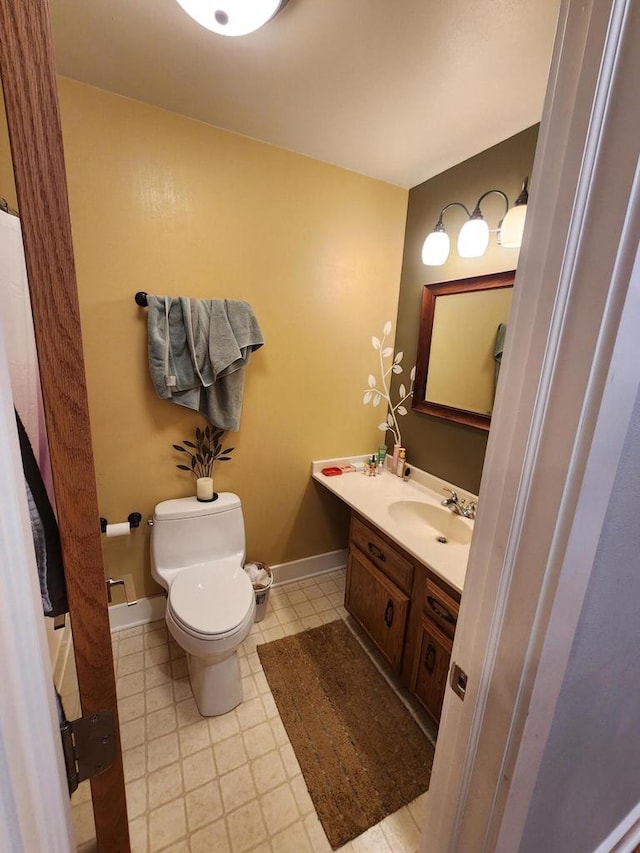 1120 W Blackhawk Dr, Fort Atkinson, WI 53538 - bathroom with toilet, vanity, and baseboards