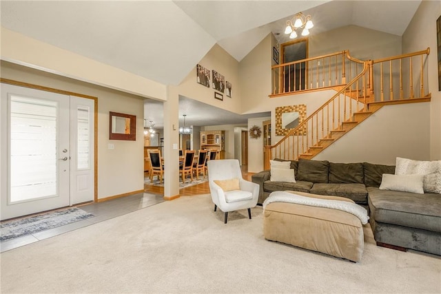 carpeted living room featuring a chandelier, stairway, and high vaulted ceiling