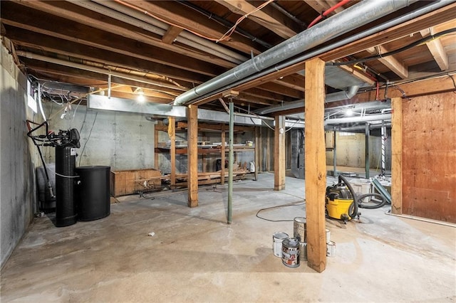 unfinished below grade area with a water softener system