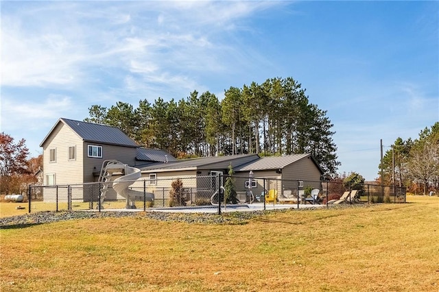 back of house featuring metal roof