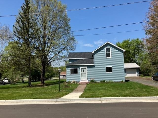 119 E 1st St, Dresser, WI 54009 - traditional-style home featuring a front lawn and a shingled roof