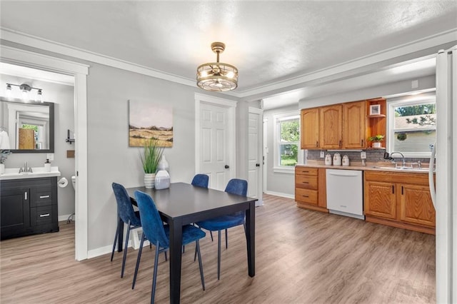 119 E 1st St, Dresser, WI 54009 - dining room with light wood-style floors, baseboards, crown molding, and a chandelier