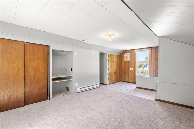119 E 1st St, Dresser, WI 54009 - unfurnished bedroom featuring a baseboard radiator, carpet, vaulted ceiling, and wooden walls