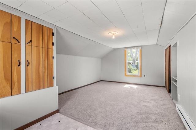 119 E 1st St, Dresser, WI 54009 - additional living space featuring baseboard heating, light carpet, baseboards, and vaulted ceiling
