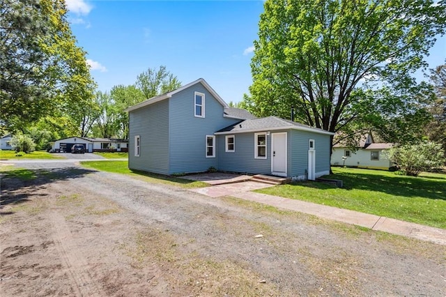119 E 1st St, Dresser, WI 54009 - rear view of property with driveway and a lawn