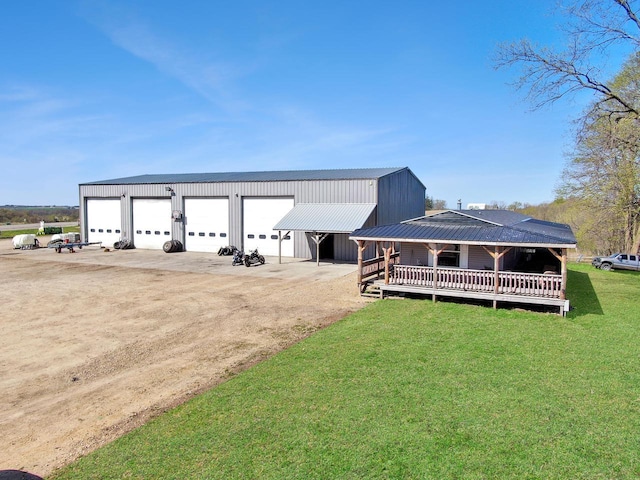 E15520 State Highway 82, Hillsboro, WI 54634 - view of front of home featuring driveway, a garage, a front yard, an outbuilding, and metal roof