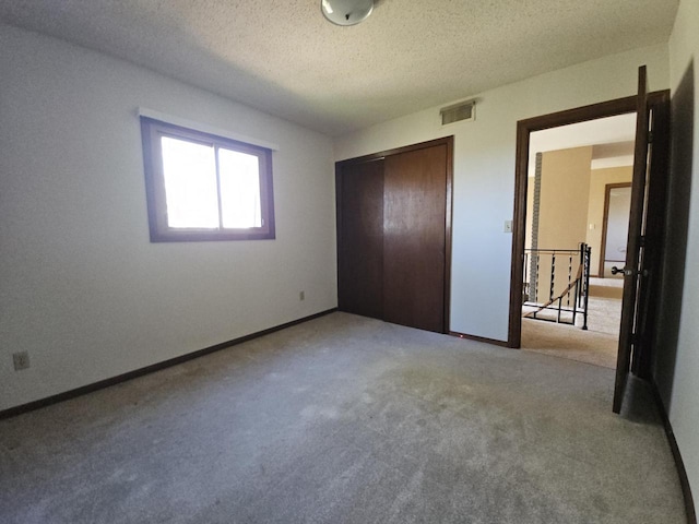 14704 Geneva Rd, Sparta, WI 54656 - unfurnished bedroom featuring carpet flooring, a closet, a textured ceiling, and baseboards