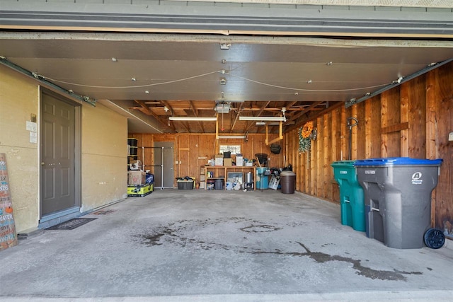 840 Waterworks Rd, Nekoosa, WI 54457 - garage featuring a garage door opener and wooden walls