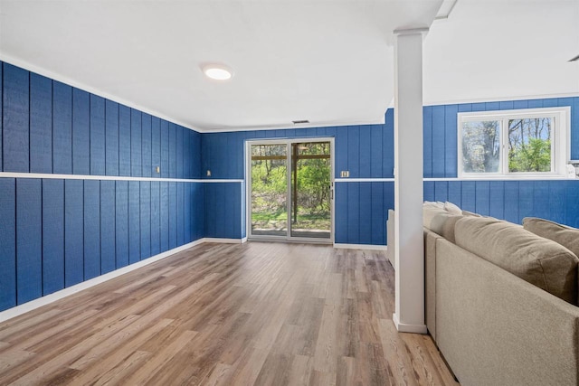 840 Waterworks Rd, Nekoosa, WI 54457 - living area featuring wood finished floors, baseboards, ornamental molding, ornate columns, and wooden walls