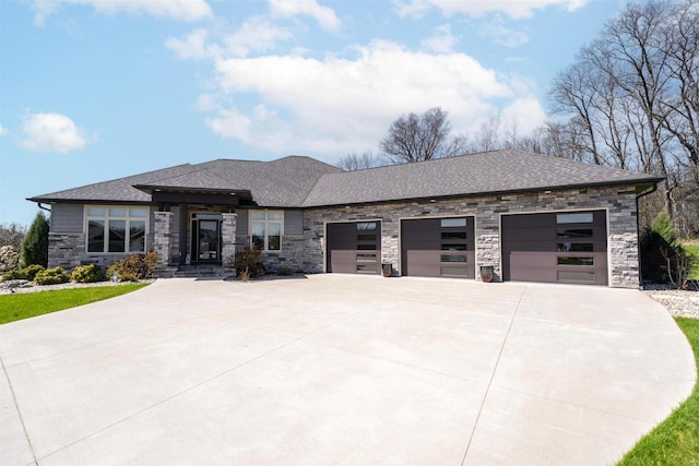 900 Woodcrest Heights Dr, Menasha, WI 54952 - prairie-style house with concrete driveway, stone siding, an attached garage, and roof with shingles