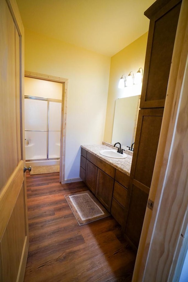 16845 Hawk Rd, Sparta, WI 54656 - bathroom with wood finished floors, vanity, and a shower