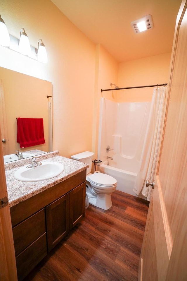 16845 Hawk Rd, Sparta, WI 54656 - full bathroom featuring wood finished floors, vanity, toilet, and shower / bathtub combination with curtain