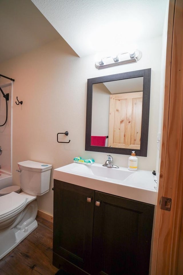 16845 Hawk Rd, Sparta, WI 54656 - full bathroom featuring toilet, vanity, bathtub / shower combination, and wood finished floors
