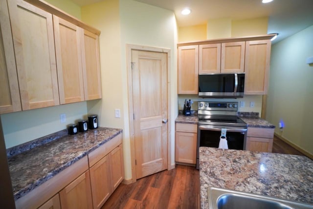 16845 Hawk Rd, Sparta, WI 54656 - kitchen with stainless steel appliances, light brown cabinetry, dark wood-type flooring, a sink, and dark stone counters
