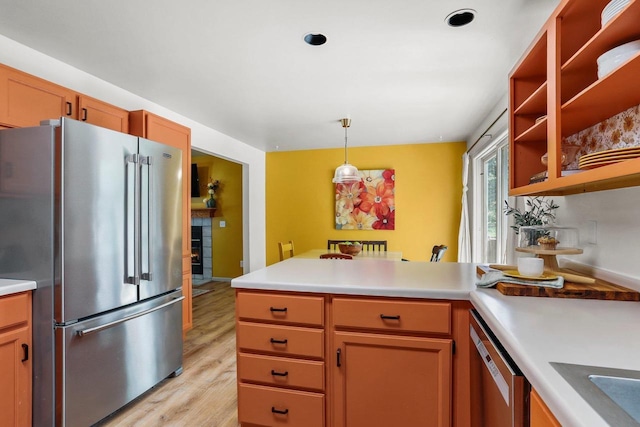 26 Prentice Pl, Madison, WI 53704 - kitchen featuring appliances with stainless steel finishes, a peninsula, light wood-style floors, and light countertops