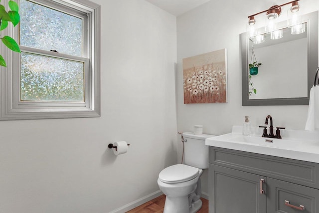 26 Prentice Pl, Madison, WI 53704 - bathroom with baseboards, toilet, vanity, and wood finished floors