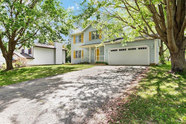 26 Prentice Pl, Madison, WI 53704 - traditional home featuring covered porch, an attached garage, a front yard, and driveway