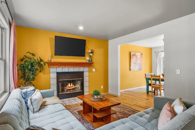 26 Prentice Pl, Madison, WI 53704 - living room with wood finished floors, a tiled fireplace, recessed lighting, and baseboards