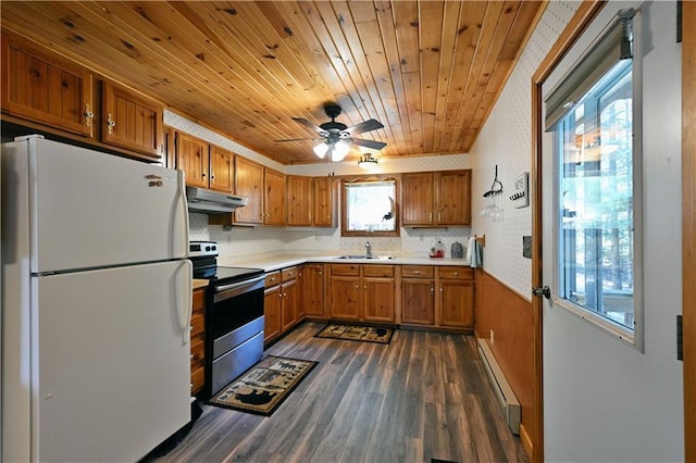 47025 Twin Pines Ln, Cable, WI 54821 - kitchen featuring freestanding refrigerator, stainless steel range with electric stovetop, baseboard heating, under cabinet range hood, and brown cabinetry