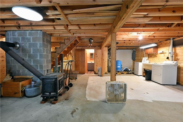 47025 Twin Pines Ln, Cable, WI 54821 - basement featuring a wood stove, a water pressure tank, washing machine and dryer, stairway, and water heater