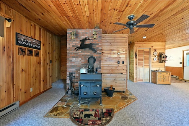 47025 Twin Pines Ln, Cable, WI 54821 - living area with carpet floors, wooden walls, wooden ceiling, a baseboard heating unit, and a wood stove