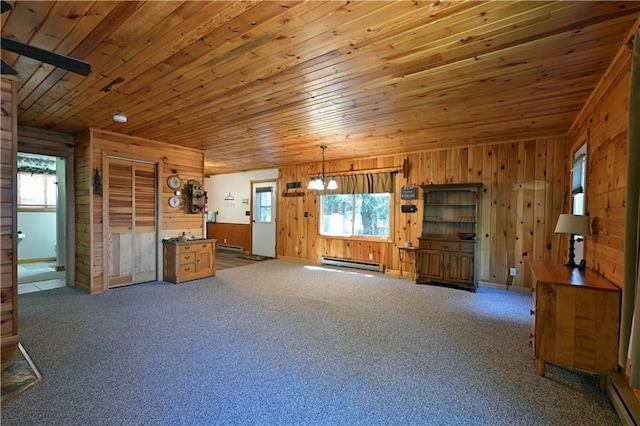 47025 Twin Pines Ln, Cable, WI 54821 - unfurnished living room with baseboard heating, wooden ceiling, wood walls, healthy amount of natural light, and carpet floors