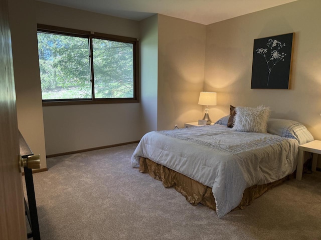 bedroom featuring carpet flooring and baseboards