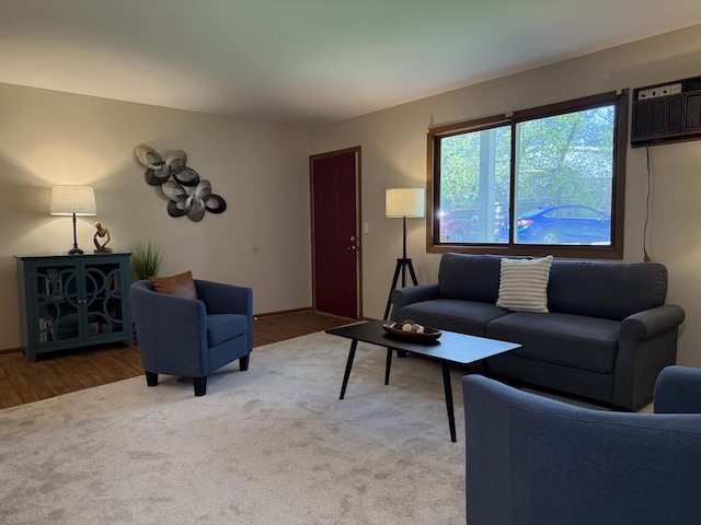 living room featuring carpet floors and an AC wall unit