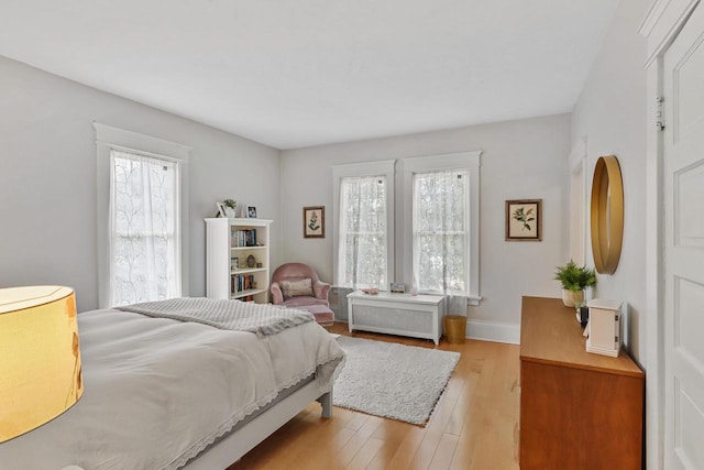 350 Madison St, Wisconsin Rapids, WI 54494 - bedroom featuring multiple windows, light wood-style flooring, and baseboards