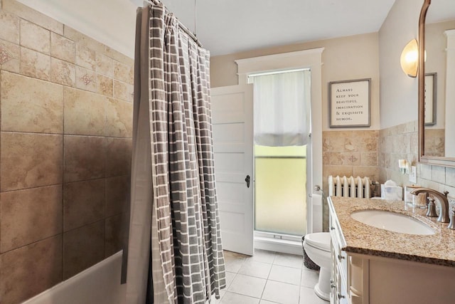 350 Madison St, Wisconsin Rapids, WI 54494 - full bathroom with tile patterned floors, toilet, vanity, and tile walls
