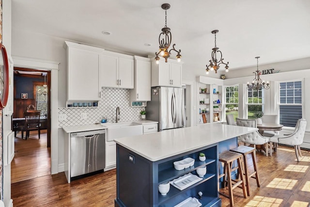 350 Madison St, Wisconsin Rapids, WI 54494 - kitchen with open shelves, stainless steel appliances, a sink, a chandelier, and light countertops