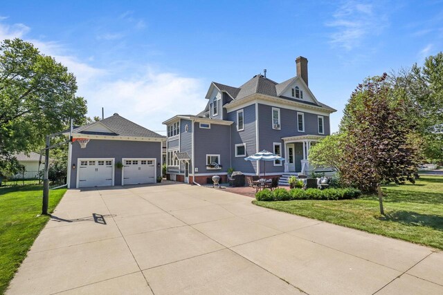 350 Madison St, Wisconsin Rapids, WI 54494 - view of front of house featuring a front lawn and a chimney