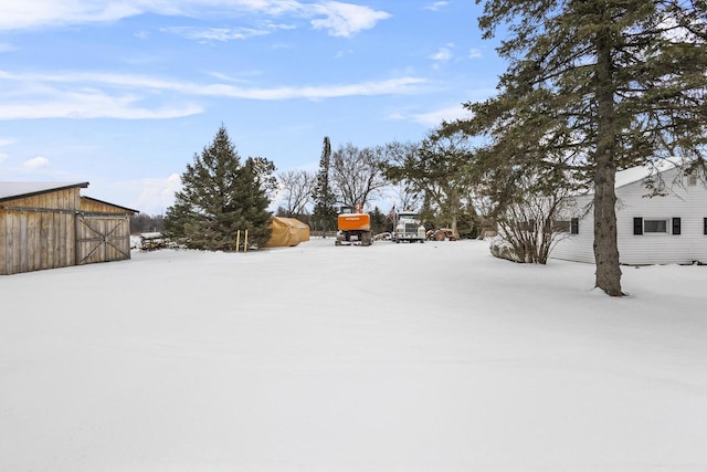 N10066 State Highway 180, Wausaukee, WI 54177 - snowy yard with an outdoor structure and a barn