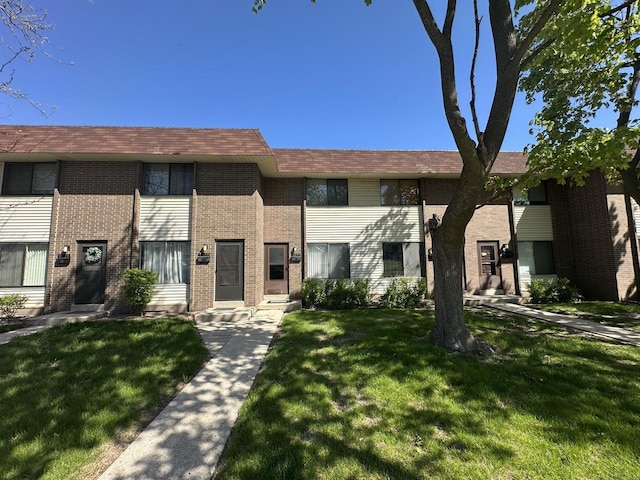 6054 W Port Ave, Milwaukee, WI 53223 - view of property with a front lawn and brick siding