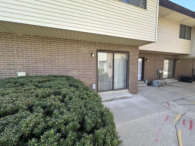 6054 W Port Ave, Milwaukee, WI 53223 - property entrance featuring brick siding and a patio area