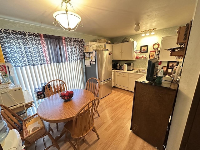6054 W Port Ave, Milwaukee, WI 53223 - dining room featuring light wood-style flooring