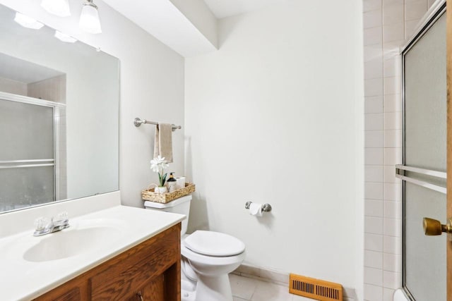 1445 17th Ave, Grafton, WI 53024 - full bathroom featuring a tile shower, toilet, tile patterned flooring, and vanity