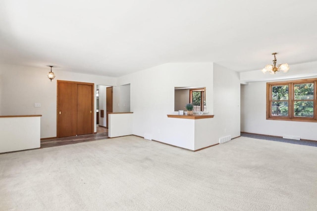 1445 17th Ave, Grafton, WI 53024 - unfurnished living room with a chandelier, carpet, and baseboards