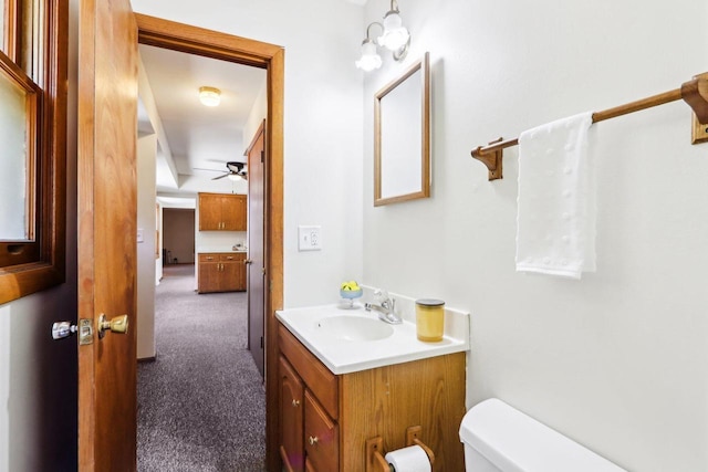 1445 17th Ave, Grafton, WI 53024 - bathroom featuring vanity, toilet, and ceiling fan