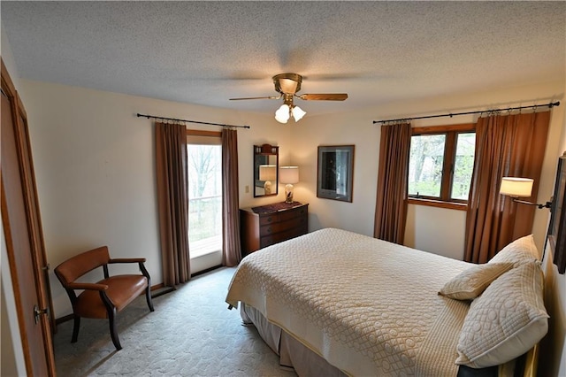 23075 Missionary Point Dr, Cable, WI 54821 - bedroom featuring light colored carpet, ceiling fan, and a textured ceiling