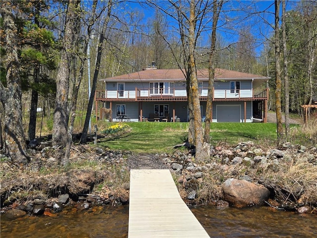 23075 Missionary Point Dr, Cable, WI 54821 - back of property featuring a yard, an attached garage, a deck, and a chimney