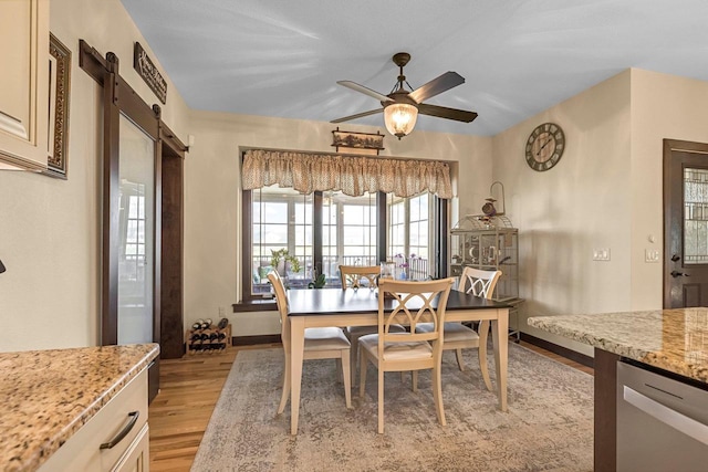 335 Bella Way, Sun Prairie, WI 53590 - dining area with light wood-style flooring, a ceiling fan, and baseboards