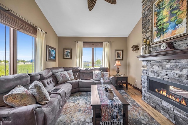 335 Bella Way, Sun Prairie, WI 53590 - living area with wood finished floors, high vaulted ceiling, a fireplace, and a ceiling fan
