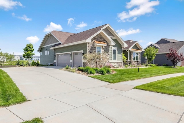 335 Bella Way, Sun Prairie, WI 53590 - craftsman house featuring stone siding, a garage, concrete driveway, a front yard, and a residential view