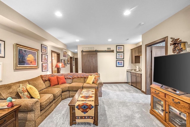 335 Bella Way, Sun Prairie, WI 53590 - living area with light colored carpet, a barn door, recessed lighting, and baseboards